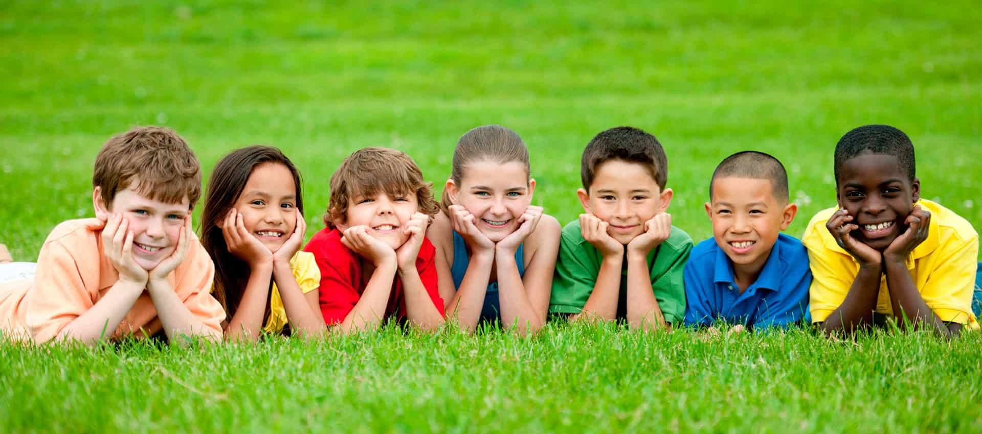 Kids in grass smiling